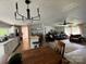 Open-concept living room showcases a modern chandelier, a ceiling fan, and a seamless flow into the kitchen at 179 Abington Ln, Troutman, NC 28166