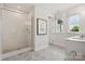 Modern bathroom with glass enclosed shower featuring sleek tilework and a window for natural light at 217 Halemarg Dr, Belmont, NC 28012