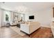 Sunlit living room with hardwood floors, comfortable seating, and a contemporary chandelier at 217 Halemarg Dr, Belmont, NC 28012