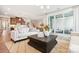 Open-concept living room showcasing hardwood floors, large windows, and seamless flow into the kitchen at 217 Halemarg Dr, Belmont, NC 28012