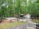 Backyard featuring a deck, shed, hammock and natural surrounding at 2206 Golden Larch Ln, Waxhaw, NC 28173