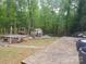 Inviting backyard with a large brick patio, deck, shed, and mature trees at 2206 Golden Larch Ln, Waxhaw, NC 28173
