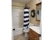 Cozy bathroom featuring a tub, shower with striped curtain, and framed mirror at 2206 Golden Larch Ln, Waxhaw, NC 28173