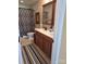 Bathroom featuring a double vanity, tiled floor, framed mirror and shower with curtain at 2206 Golden Larch Ln, Waxhaw, NC 28173