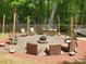 An outdoor stone fire pit surrounded by chairs for cozy gatherings at 2206 Golden Larch Ln, Waxhaw, NC 28173