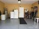 Clean and functional garage interior with a refrigerator and epoxy flooring at 2206 Golden Larch Ln, Waxhaw, NC 28173