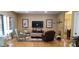 Spacious living room with gleaming hardwood floors, a neutral color palette, and comfortable furniture at 2206 Golden Larch Ln, Waxhaw, NC 28173