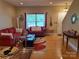 Inviting living room featuring hardwood floors, a bright window, and comfortable seating at 2206 Golden Larch Ln, Waxhaw, NC 28173