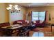 Comfortable living room featuring hardwood floors, a bright window, and ample seating at 2206 Golden Larch Ln, Waxhaw, NC 28173