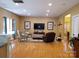 Spacious living room with gleaming hardwood floors, a neutral color palette, and modern furniture at 2206 Golden Larch Ln, Waxhaw, NC 28173