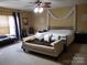 Comfortable main bedroom featuring a ceiling fan, bench, and neutral walls at 2206 Golden Larch Ln, Waxhaw, NC 28173