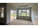 Under-construction dining area with backyard views through sliding glass door, and backyard views through window at 2229 Camber Dr # Cwo0100, Gastonia, NC 28054
