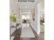 Inviting hallway featuring hardwood floors, decorative wall art, and an elegant display table for a welcoming home ambiance at 2229 Camber Dr # Cwo0100, Gastonia, NC 28054