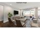 Bright, staged living room featuring hardwood floors, a comfortable white sectional sofa, and ample natural light from large windows at 2229 Camber Dr # Cwo0100, Gastonia, NC 28054