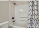 Well-lit bathroom features a bathtub with black fixtures and a shower with a patterned curtain at 2335 Brookview Ct, Rock Hill, SC 29732