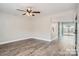 Spacious living room area with hardwood flooring, ceiling fan and adjacent kitchen area at 2335 Brookview Ct, Rock Hill, SC 29732