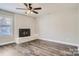 Living room with brick fireplace, hardwood floors, neutral paint and ceiling fan at 2335 Brookview Ct, Rock Hill, SC 29732