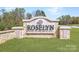 Roselyn community entrance sign surrounded by lush green grass and landscaping on a bright and sunny day at 2807 Morning Song Way, Lancaster, SC 29720