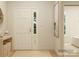Inviting entryway with a front door, wooden console table, art, and view into the living area at 2807 Morning Song Way, Lancaster, SC 29720