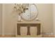 Bright entryway featuring decorative vases, a wooden console table, and round mirror at 2807 Morning Song Way, Lancaster, SC 29720