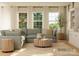 Comfortable living room with soft sectional, lots of light, and view to backyard through large windows at 2807 Morning Song Way, Lancaster, SC 29720