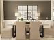 Stylish dining room featuring neutral tones, chic lighting, coordinated wall art and comfortable upholstered chairs at 2820 Morning Song Way, Lancaster, SC 29720