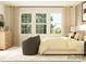 Bedroom featuring a comfortable bed, dresser, and a cozy chair near bright windows, creating a peaceful atmosphere at 2820 Morning Song Way, Lancaster, SC 29720