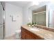 Bathroom featuring granite counters, wood cabinets and glass shower door at 300 W 5Th St # 136, Charlotte, NC 28202
