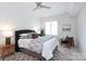 Comfortable bedroom featuring a plush bed, ceiling fan, and bright window at 300 W 5Th St # 136, Charlotte, NC 28202