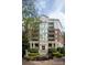 Exterior view of building featuring lush landscaping and signage at 300 W 5Th St # 136, Charlotte, NC 28202