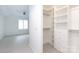 View from bedroom into walk-in closet with custom built-in shelving and drawers at 300 W 5Th St # 136, Charlotte, NC 28202