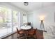 Bright dining nook with white plantation shutters with seating for three at 300 W 5Th St # 136, Charlotte, NC 28202