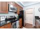 Well-lit kitchen featuring modern stainless steel appliances and wooden cabinets at 300 W 5Th St # 136, Charlotte, NC 28202