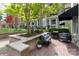 Charming patio with grill and seating area surrounded by green trees at 300 W 5Th St # 136, Charlotte, NC 28202