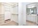Spacious walk-in closet with built-in shelving and drawers for ample storage at 300 W 5Th St # 136, Charlotte, NC 28202