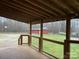 View from the back porch of the home looking out to a large yard with a barn and other outbuildings at 3014 Haigler Rd, Monroe, NC 28110