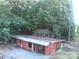 Rustic farm with multiple red barns surrounded by lush trees and greenery, ideal for agricultural pursuits or a serene escape at 3014 Haigler Rd, Monroe, NC 28110