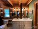 Charming bathroom featuring a wood paneled wall, double vanity, and exposed bulb vanity lighting at 3014 Haigler Rd, Monroe, NC 28110