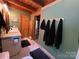 Rustic bathroom with wooden ceiling, double vanity, and modern fixtures provides a cozy and updated space at 3014 Haigler Rd, Monroe, NC 28110