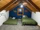 Cozy bedroom with slanted ceilings, natural light, and charming dinosaur-themed décor at 3014 Haigler Rd, Monroe, NC 28110