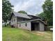 Exterior view of a log cabin home with a convenient carport and spacious backyard at 3014 Haigler Rd, Monroe, NC 28110