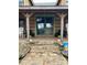 Front porch with stone steps, a teal door, and white rocking chairs at 3014 Haigler Rd, Monroe, NC 28110
