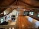 Open-concept living room boasts a stone fireplace, hardwood floors, and wood beam architectural details at 3014 Haigler Rd, Monroe, NC 28110