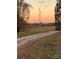 Evening sky view, showcasing the open farmland and serene countryside setting at sunset at 3014 Haigler Rd, Monroe, NC 28110