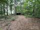 Wooded area leading to property, highlighting the natural surroundings and secluded atmosphere at 3014 Haigler Rd, Monroe, NC 28110