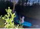 Person kayaking in a calm creek surrounded by lush greenery, capturing the tranquil outdoor lifestyle at 3014 Haigler Rd, Monroe, NC 28110