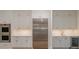Bright kitchen showcases stainless appliances and gray cabinets with gold hardware at 3131 Providence Rd # 1A, Charlotte, NC 28211