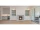 Elegant living room featuring a fireplace flanked by built-in shelving and cabinets, with access to the patio at 3131 Providence Rd # 1A, Charlotte, NC 28211
