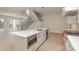 Open kitchen featuring stainless steel appliances, modern island and connecting staircase at 3131 Providence Rd # 1B, Charlotte, NC 28211