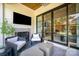 Cozy covered patio with fireplace, comfortable seating, and sliding glass doors at 3131 Providence Rd # 1B, Charlotte, NC 28211